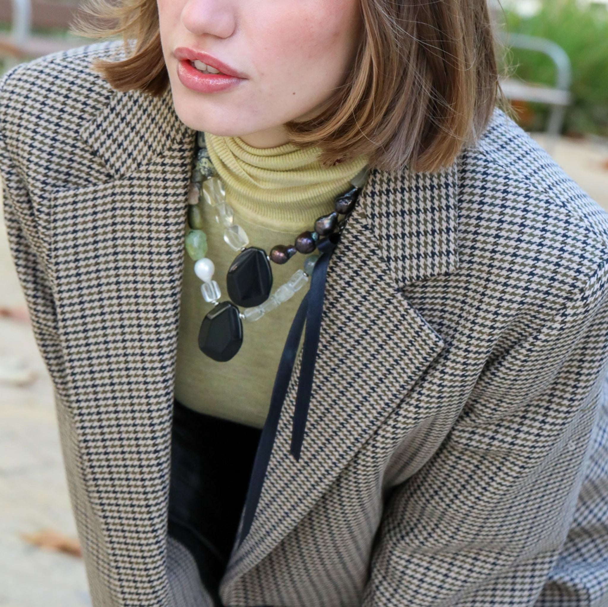 Model wearing a layered Monodiko necklace